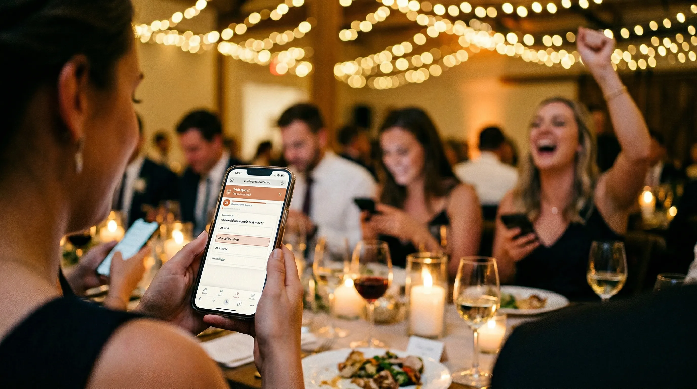 Wedding guest holding phone playing trivia while other guests compete at a reception table