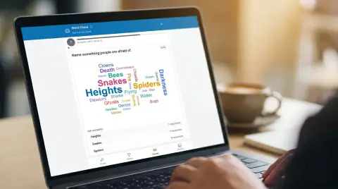 Team viewing a live word cloud on a laptop during a virtual meeting